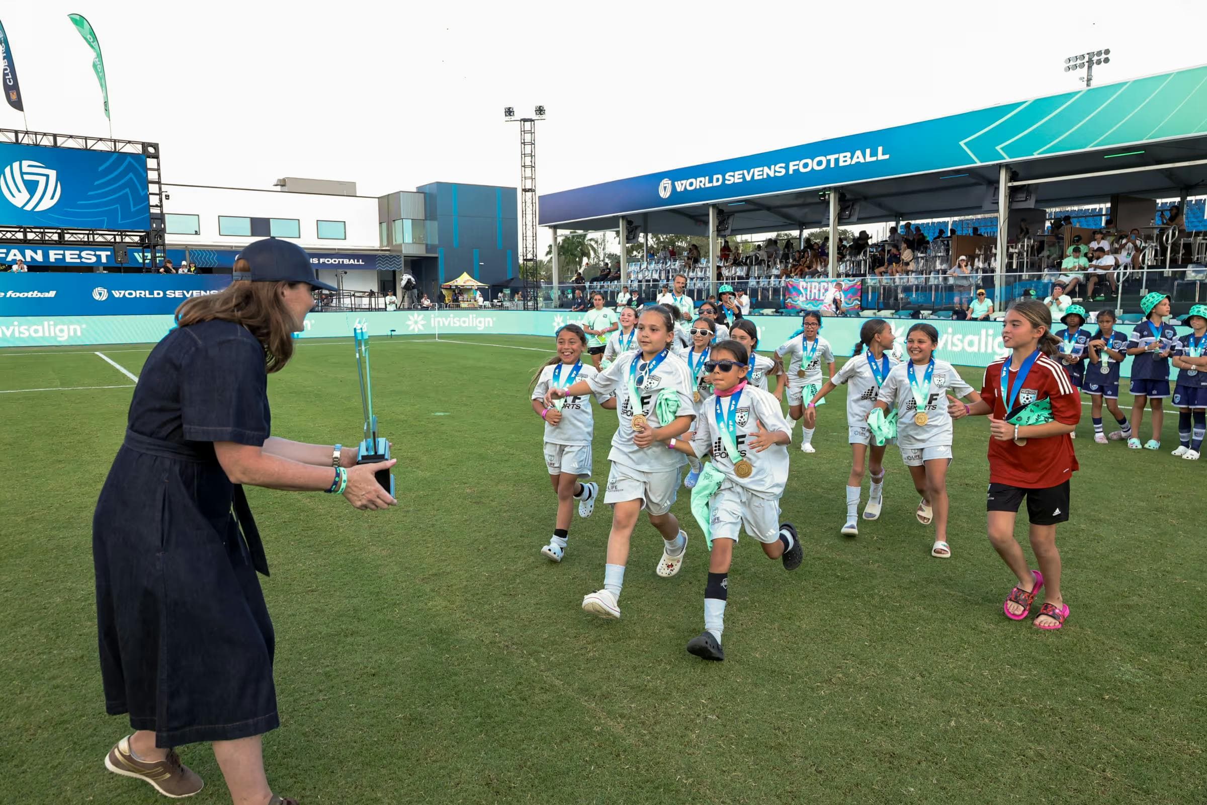 Youth soccer team being presented the trophy at Rising 7s tournament