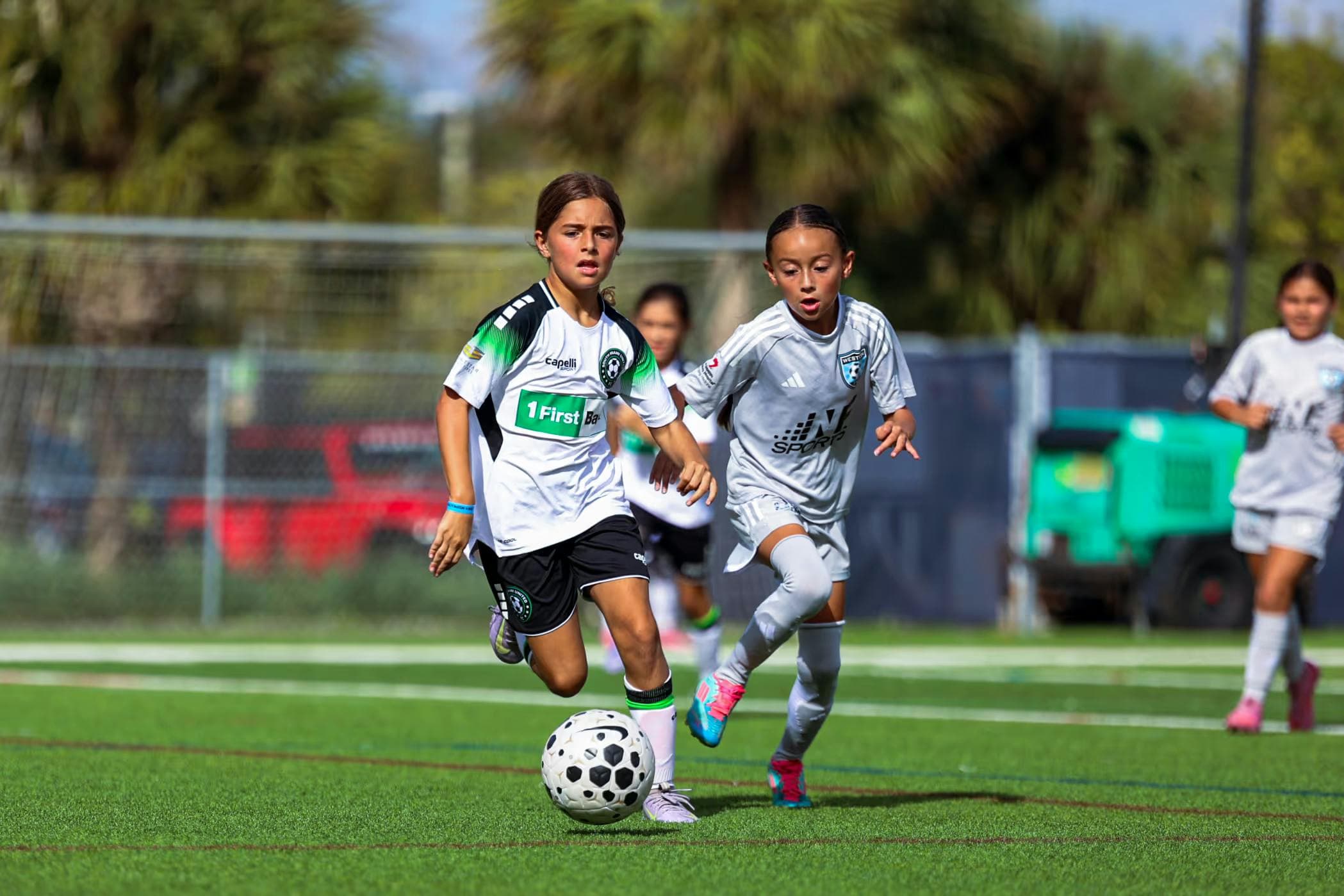 Youth Soccer game, attacker dribbling